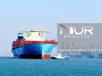 A cargo ship sails towards a foreign trade container terminal at Qianwan Port in Qingdao, China, on December 7, 2024. (