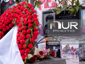 People leave flowers at the monument of Alexis Grigoropoulos in Athens, Greece, on December 6, 2024, marking the 16th anniversary of the dea...