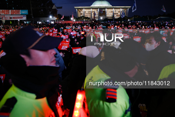 Citizens gather in Yeouido, South Korea, on December 7, 2024, to demand the impeachment and resignation of President Yoon Suk Yeol. Yoon's a...