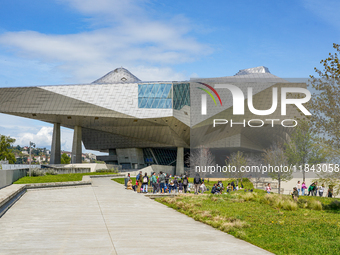 School classes and visitors gather at the Musée des Confluences in Lyon, France, on April 4, 2024. The museum stands prominently with its st...