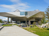 School classes and visitors gather at the Musée des Confluences in Lyon, France, on April 4, 2024. The museum stands prominently with its st...