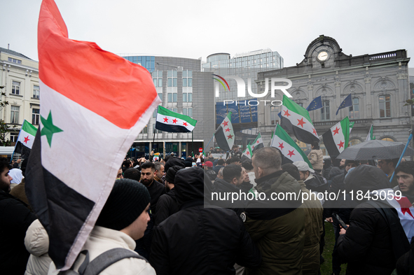 A representation of the Syrian people waves Syrian flags and chants for freedom in front of the European Parliament in Brussels, Belgium, on...