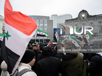 A representation of the Syrian people waves Syrian flags and chants for freedom in front of the European Parliament in Brussels, Belgium, on...