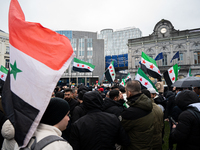 A representation of the Syrian people waves Syrian flags and chants for freedom in front of the European Parliament in Brussels, Belgium, on...