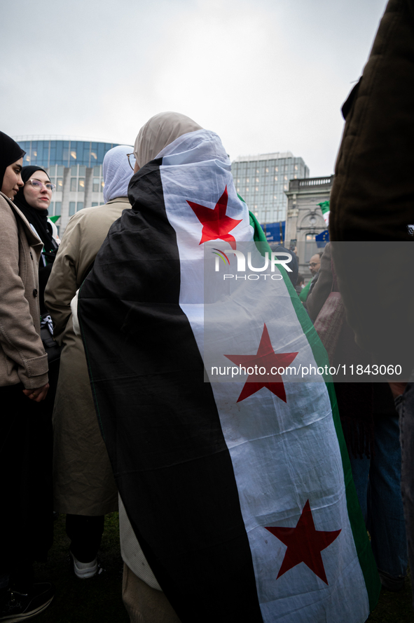 A representation of the Syrian people waves Syrian flags and chants for freedom in front of the European Parliament in Brussels, Belgium, on...