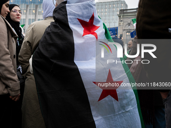 A representation of the Syrian people waves Syrian flags and chants for freedom in front of the European Parliament in Brussels, Belgium, on...