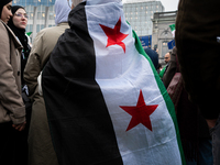 A representation of the Syrian people waves Syrian flags and chants for freedom in front of the European Parliament in Brussels, Belgium, on...