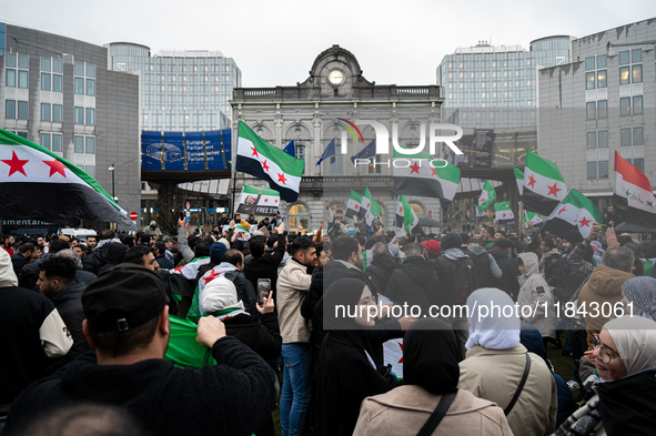 A representation of the Syrian people waves Syrian flags and chants for freedom in front of the European Parliament in Brussels, Belgium, on...