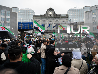 A representation of the Syrian people waves Syrian flags and chants for freedom in front of the European Parliament in Brussels, Belgium, on...