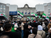 A representation of the Syrian people waves Syrian flags and chants for freedom in front of the European Parliament in Brussels, Belgium, on...