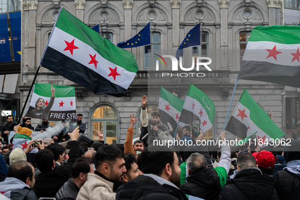 A representation of the Syrian people waves Syrian flags and chants for freedom in front of the European Parliament in Brussels, Belgium, on...