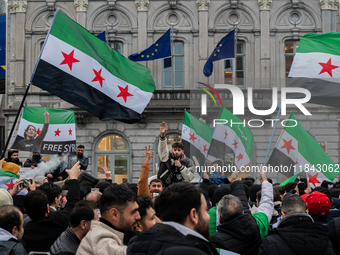 A representation of the Syrian people waves Syrian flags and chants for freedom in front of the European Parliament in Brussels, Belgium, on...