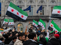 A representation of the Syrian people waves Syrian flags and chants for freedom in front of the European Parliament in Brussels, Belgium, on...