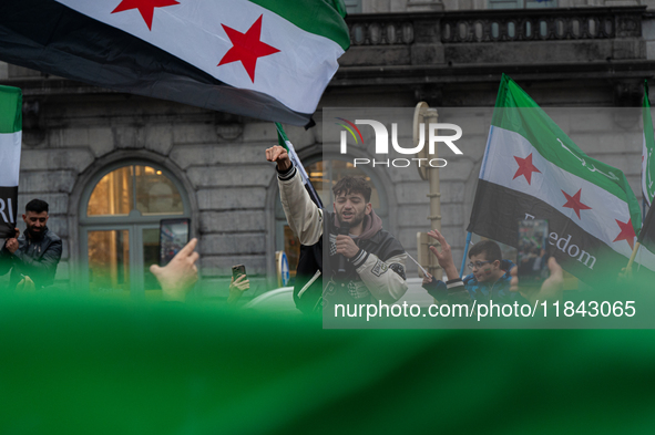 A representation of the Syrian people waves Syrian flags and chants for freedom in front of the European Parliament in Brussels, Belgium, on...