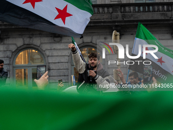 A representation of the Syrian people waves Syrian flags and chants for freedom in front of the European Parliament in Brussels, Belgium, on...