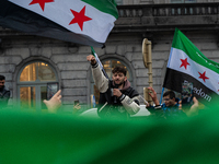 A representation of the Syrian people waves Syrian flags and chants for freedom in front of the European Parliament in Brussels, Belgium, on...