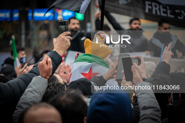 A representation of the Syrian people waves Syrian flags and chants for freedom in front of the European Parliament in Brussels, Belgium, on...