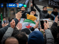 A representation of the Syrian people waves Syrian flags and chants for freedom in front of the European Parliament in Brussels, Belgium, on...