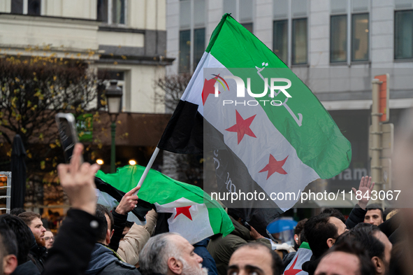 A representation of the Syrian people waves Syrian flags and chants for freedom in front of the European Parliament in Brussels, Belgium, on...