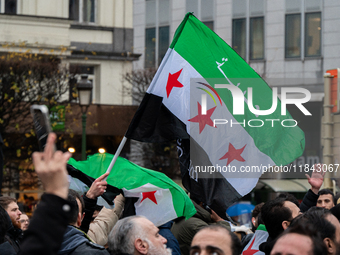 A representation of the Syrian people waves Syrian flags and chants for freedom in front of the European Parliament in Brussels, Belgium, on...