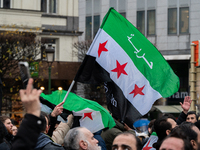 A representation of the Syrian people waves Syrian flags and chants for freedom in front of the European Parliament in Brussels, Belgium, on...