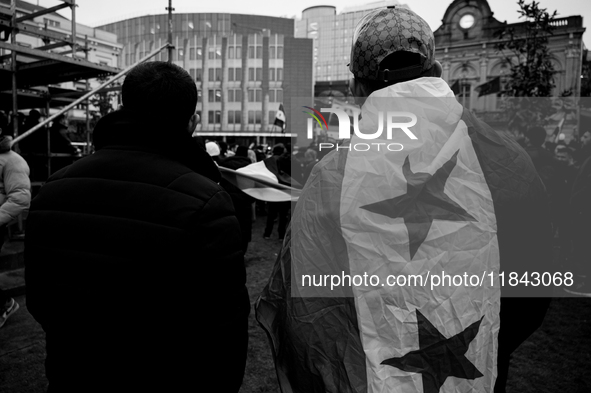 A representation of the Syrian people waves Syrian flags and chants for freedom in front of the European Parliament in Brussels, Belgium, on...