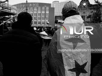 A representation of the Syrian people waves Syrian flags and chants for freedom in front of the European Parliament in Brussels, Belgium, on...