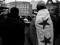 A representation of the Syrian people waves Syrian flags and chants for freedom in front of the European Parliament in Brussels, Belgium, on...