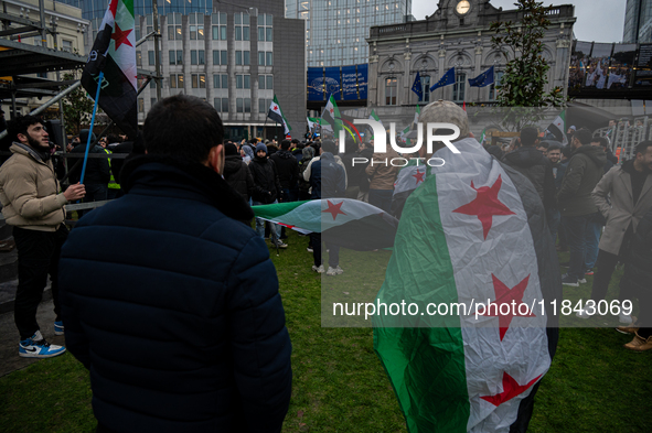 A representation of the Syrian people waves Syrian flags and chants for freedom in front of the European Parliament in Brussels, Belgium, on...