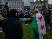 A representation of the Syrian people waves Syrian flags and chants for freedom in front of the European Parliament in Brussels, Belgium, on...