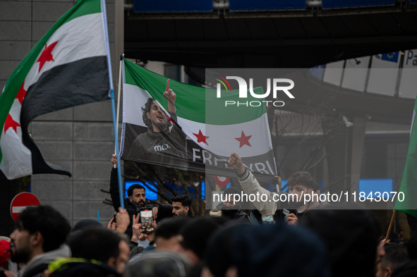 A representation of the Syrian people waves Syrian flags and chants for freedom in front of the European Parliament in Brussels, Belgium, on...