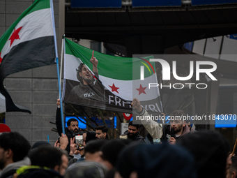 A representation of the Syrian people waves Syrian flags and chants for freedom in front of the European Parliament in Brussels, Belgium, on...