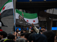 A representation of the Syrian people waves Syrian flags and chants for freedom in front of the European Parliament in Brussels, Belgium, on...