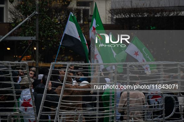 A representation of the Syrian people waves Syrian flags and chants for freedom in front of the European Parliament in Brussels, Belgium, on...