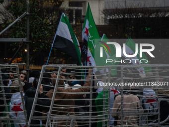 A representation of the Syrian people waves Syrian flags and chants for freedom in front of the European Parliament in Brussels, Belgium, on...