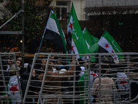 A representation of the Syrian people waves Syrian flags and chants for freedom in front of the European Parliament in Brussels, Belgium, on...