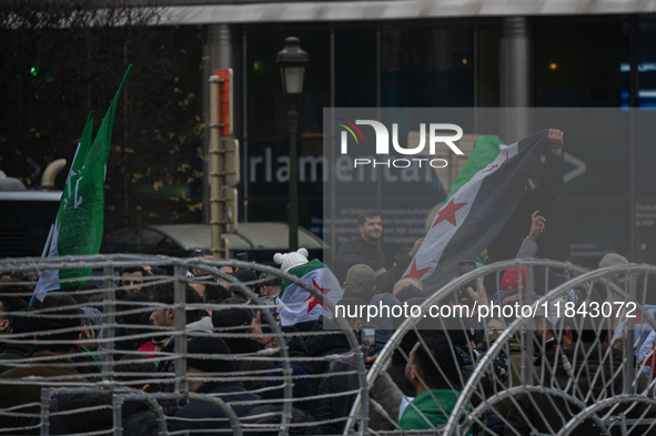 A representation of the Syrian people waves Syrian flags and chants for freedom in front of the European Parliament in Brussels, Belgium, on...