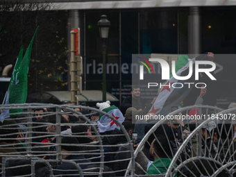 A representation of the Syrian people waves Syrian flags and chants for freedom in front of the European Parliament in Brussels, Belgium, on...