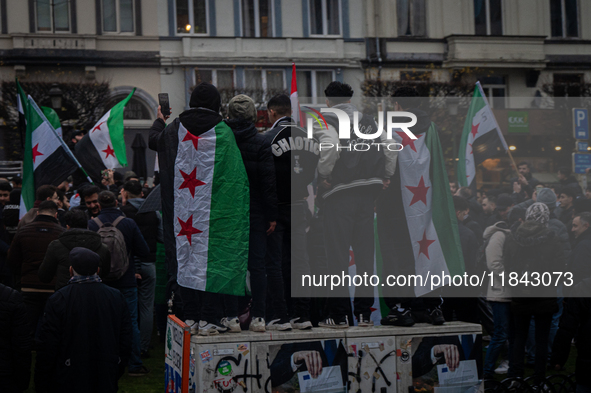 A representation of the Syrian people waves Syrian flags and chants for freedom in front of the European Parliament in Brussels, Belgium, on...