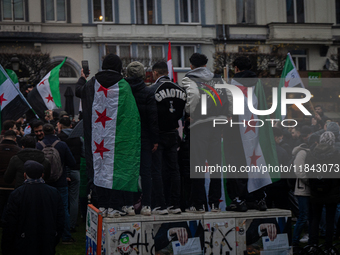 A representation of the Syrian people waves Syrian flags and chants for freedom in front of the European Parliament in Brussels, Belgium, on...