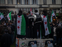 A representation of the Syrian people waves Syrian flags and chants for freedom in front of the European Parliament in Brussels, Belgium, on...