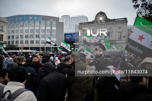 A representation of the Syrian people waves Syrian flags and chants for freedom in front of the European Parliament in Brussels, Belgium, on...