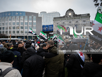 A representation of the Syrian people waves Syrian flags and chants for freedom in front of the European Parliament in Brussels, Belgium, on...