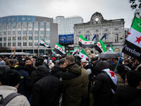 A representation of the Syrian people waves Syrian flags and chants for freedom in front of the European Parliament in Brussels, Belgium, on...