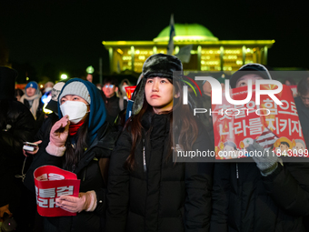 Supporters of President Yoon Suk-yeol's impeachment shed tears after the motion is rejected in the National Assembly. On December 7, 2024, i...