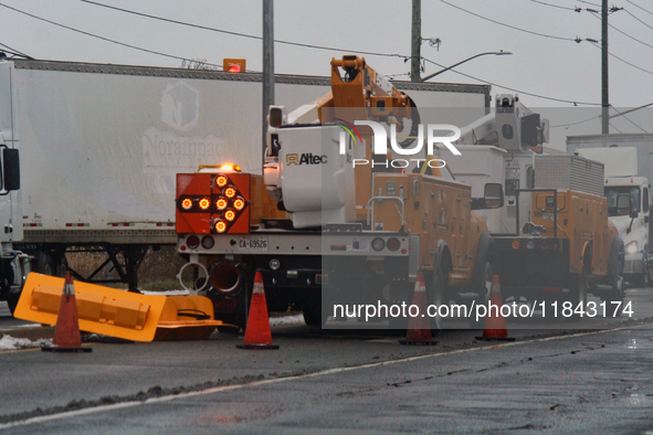 Workers install new traffic lights in Mississauga, Ontario, Canada, on December 4, 2024. 