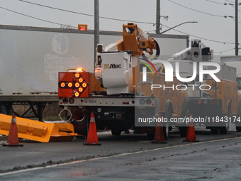 Workers install new traffic lights in Mississauga, Ontario, Canada, on December 4, 2024. (