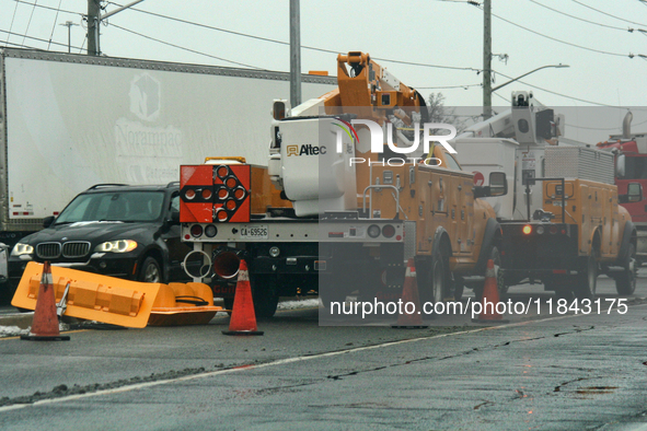 Workers install new traffic lights in Mississauga, Ontario, Canada, on December 4, 2024. 