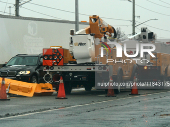 Workers install new traffic lights in Mississauga, Ontario, Canada, on December 4, 2024. (