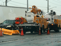 Workers install new traffic lights in Mississauga, Ontario, Canada, on December 4, 2024. (